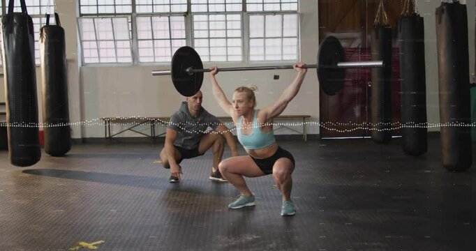 Female athlete bracing core initiating squat in gym for health gain with animated gauge filling
