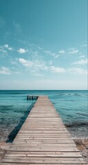 Obraz premium Serene wooden pier extending into a calm, turquoise ocean under a vibrant blue sky dotted with fluffy white clouds