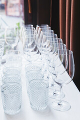 Elegant arrangement of clean glassware at an event preparation location