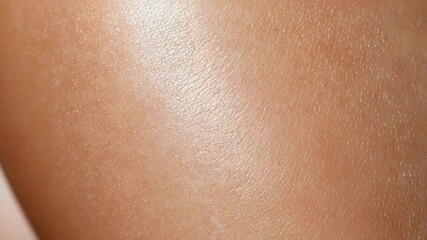 A close-up view of smooth skin with a natural texture and sheen.