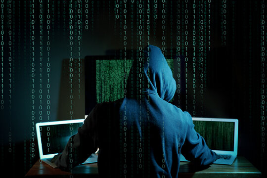 Cyber attack. Hacker working on computers in dark room. Binary code around him - Powered by Adobe