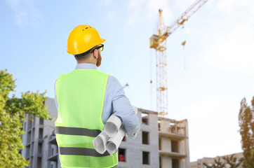 Engineer in safety equipment looking at construction site