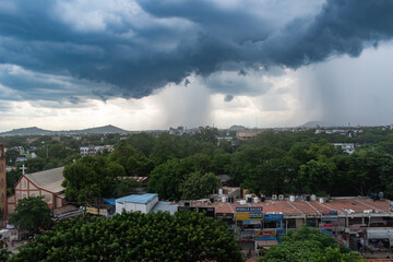 Dark clouds loom over Madurai as rain approaches, creating a moody atmosphere in the city skyline