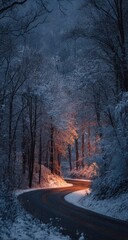 Snow-covered winding road through a dimly lit, snow-laden forest at twilight, illuminated by warm light