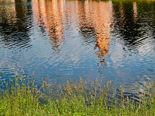 Dramatic water reflections at summer lake landscape backdrop