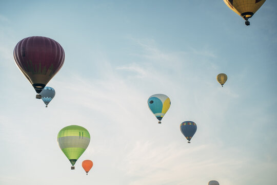Group of colorful hot air balloons flying in blue sky during festival