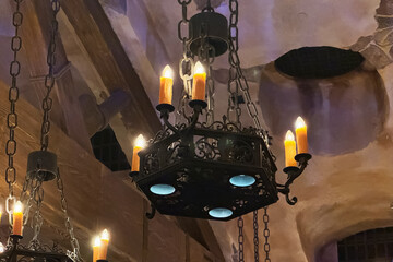 Elegant vintage chandelier lights up rustic room in historic setting