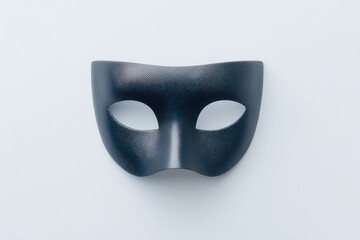 silhouette of theater mask gently illuminated floating against plain white backdrop