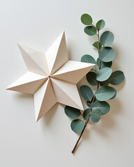 Elegant Paper Star Decoration with Eucalyptus Leaves on a Neutral Background
