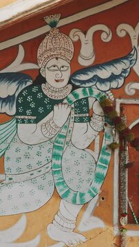 Close-up View On Old-painted Walls. Frescoes On Once Of Fortress Gates In Jaipur. Religious Motifs Of Hinduism. Architecture Of Jaipur Or Pink City Due To Dominant Color Scheme Of Its Buildings In Old