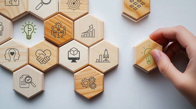 Design Thinking Process concept. Wooden blocks with icons; the key stages of the design thinking process, a solution-focused, problem-solving methodology used for innovation and strategic development.