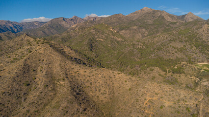Rugged Hills and Winding Road Near Nerja, Captured by Drone