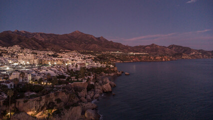 Drone Capture of Nerja's Seaside and Hills at Sunset