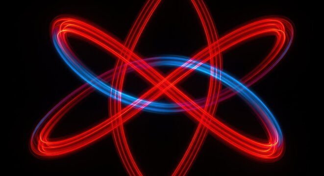Abstract light painting of intersecting red and blue orbital shapes against black background.