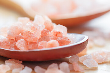 Closeup view of wooden spoons with Himalayan salt crystals