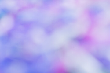 Image features an abstract, colorful blur with shades of pink, purple, and blue, creating a dreamy and soft bokeh effect.