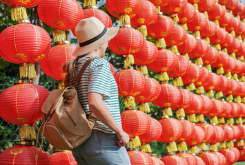 Female tourist enjoying view of traditional Chinese red lanterns