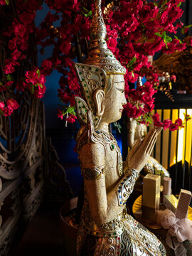 Ornate praying statue with flowers, Georgetown, Malaysia