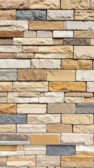Stone Wall Texture: A detailed close-up of a multi-colored stone wall. The texture and pattern are beautiful. It's a classic background for design projects.