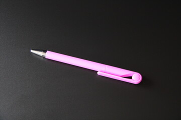 purple pen on black background,