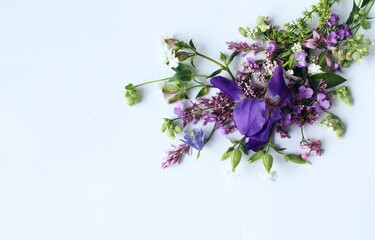 A summer bouquet with an iris in lilac tones.  A flower arrangement with a place for text.