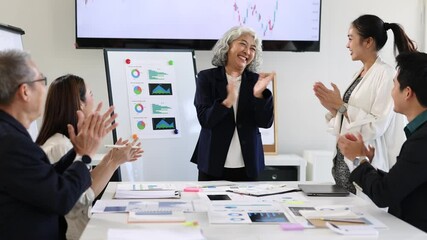 Business team congratulating senior manager after successful meeting. - Powered by Adobe