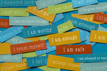 Affirmations or positive mindsets written on colorful papers, positive thinking, I am enough, safe, worthy