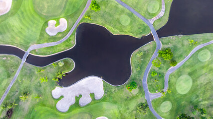 Aerial top view golf course with lush greens, green fairway and sand bunker, Golf course green grass and trees fairway and putting green, Beautiful golf course.