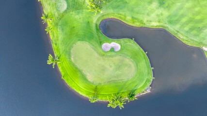 Aerial top view golf course with lush greens, green fairway and sand bunker, Golf course green grass and trees fairway and putting green, Beautiful golf course.