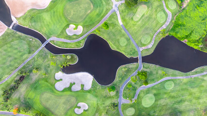 Aerial top view golf course with lush greens, green fairway and sand bunker, Golf course green grass and trees fairway and putting green, Beautiful golf course.