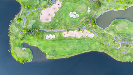 Aerial top view golf course with lush greens, green fairway and sand bunker, Golf course green grass and trees fairway and putting green, Beautiful golf course.