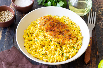 Orzo pasta with roasted chicken breast and curry sauce. Recipe. Healthy eating.