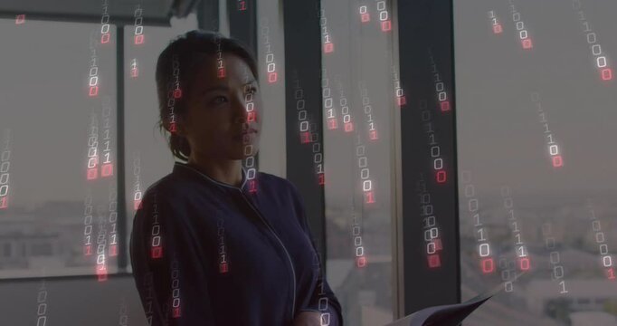 Business professional reading folder by office window and overlaying binary code for data analysis