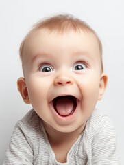 Happy surprised smiling baby with wide open mouth and big expressive eyes