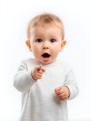 Surprised baby child with wide eyes and open mouth pointing at viewer in white background