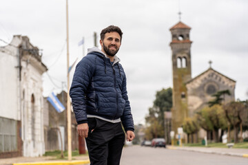 Man smiling on street with historic church in background
