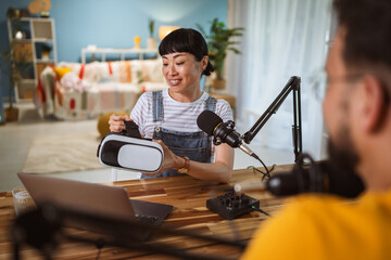 Excited japanese woman wear virtual goggles at home studio