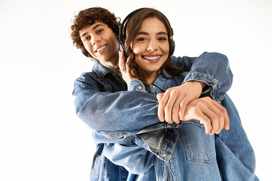 Young couple sharing joy and style while listening to music in a bright setting