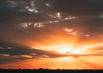 Amazing Golden Sunset Sunrise Sky Background. Natural Bright Dramatic Sky In Sunset Dawn Sunrise. Warm Yellow And Orange Colors