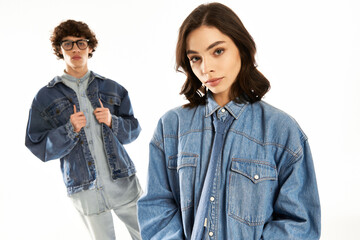Stylish young couple showcases their trendy denim fashion in a bright studio setting