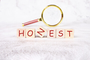 The concept word HONEST is assembled from cubes. Business integrity ethics honesty respect concept