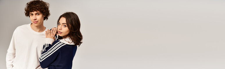 Young stylish couple expressing love and joy in a minimalistic setting