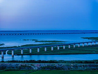 Railway bridge over green farmland