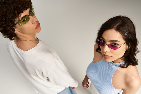 Young couple showcasing modern fashion trends and vibrant summer style with confidence and flair