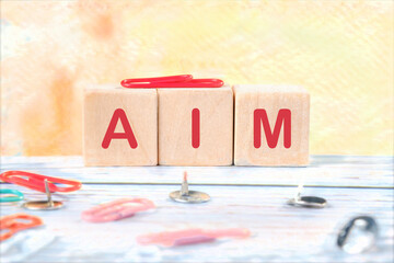 The AIM concept word is assembled from cubes. Business concept