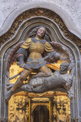 Obraz premium Saint Thecla’s cathedral, Tarragona, Spain. Apse sculpture : Saint Michael and the dragon