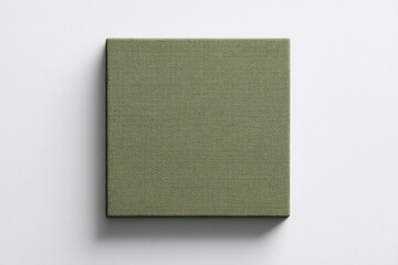 A square, muted olive-green canvas print rests on a stark white background, showcasing a subtly textured fabric surface