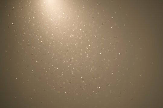 Dust particles suspended in air illuminated by a light source above