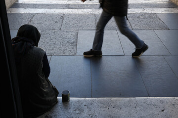 Woman begging outside Santa Maria dei miracoli church, Rome, Italy