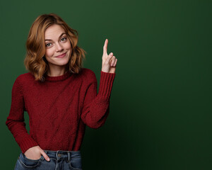Full-Body Portrait of a Happy Woman in a Red Sweater and Blue Jeans, Pointing to the Side on a Green Background – Studio-Quality Lighting, Perfect for Advertising & Marketing